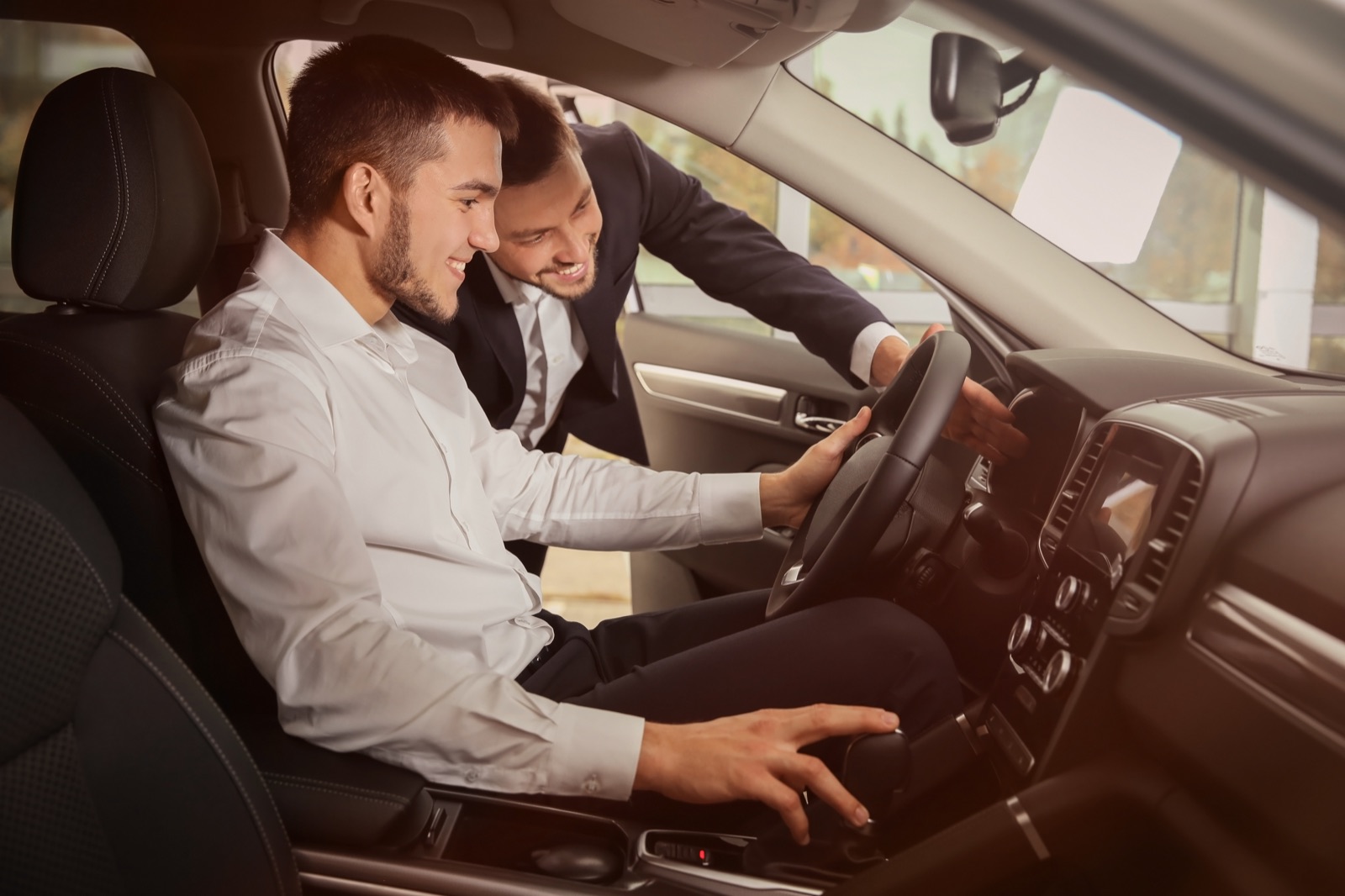 Customer reviewing vehicle options with a dealership consultant