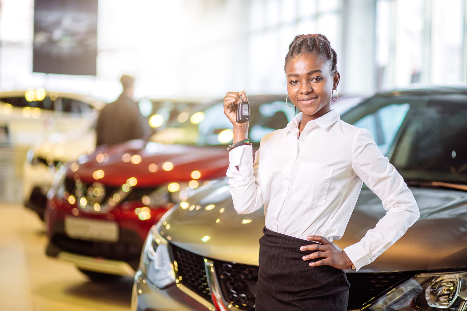 Dealership representative holding a vehicle key